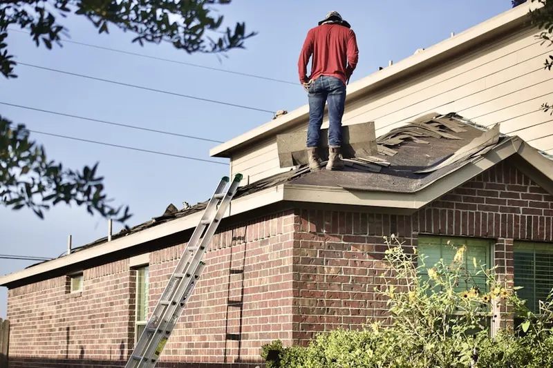 Professional roofer working on a residential roof in Dickson City